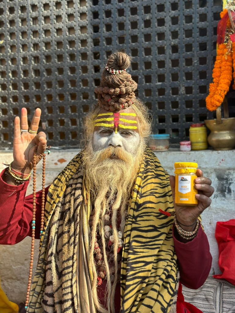 A spritual guru holding pure mad honey from himalayan hunters.
